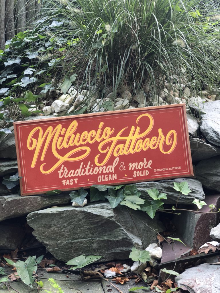 Handpainted wooden sign for millucio tattooer